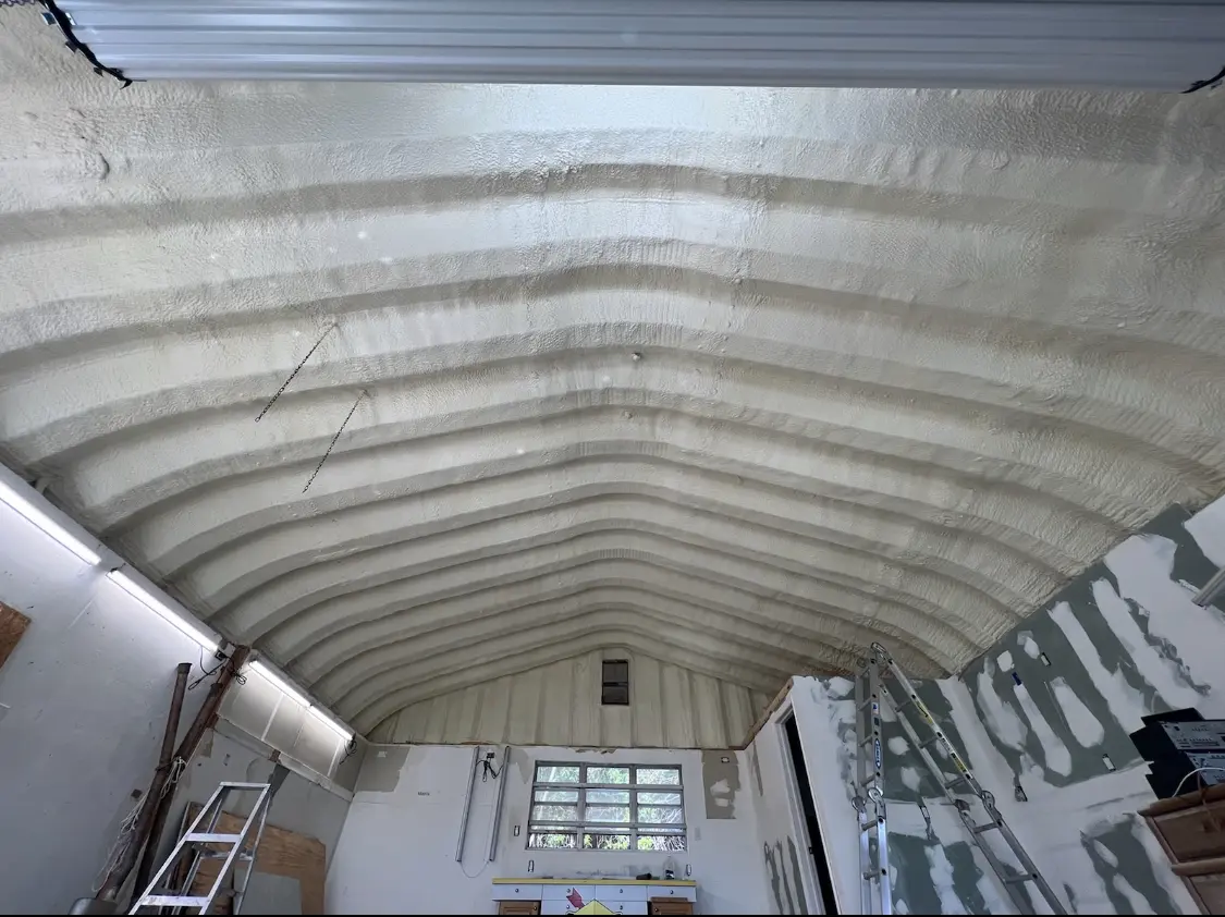 Spray polyurethane foam applied to the underside of a metal roof deck in Del City